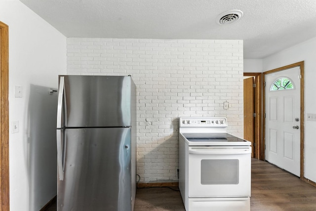4951 Newton Ave N, Minneapolis, MN 55430 - kitchen with freestanding refrigerator, white electric range oven, dark wood finished floors, a textured ceiling, and brick wall
