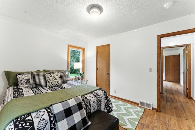 4951 Newton Ave N, Minneapolis, MN 55430 - bedroom with wood finished floors, a textured ceiling, and ornamental molding