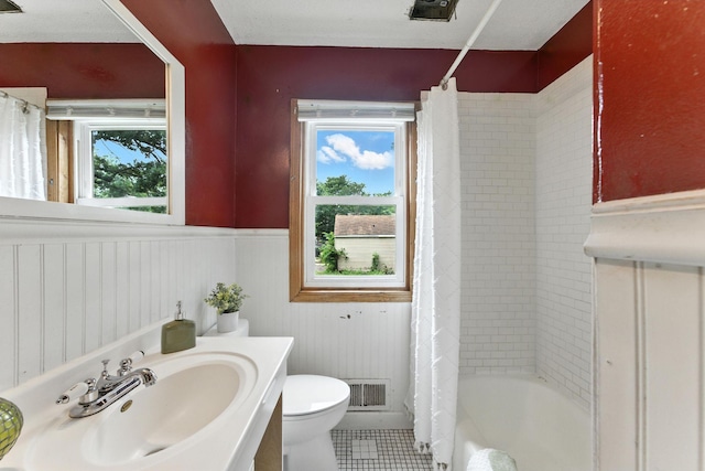 4951 Newton Ave N, Minneapolis, MN 55430 - full bath with wainscoting, tile patterned flooring, vanity, and shower / tub combo