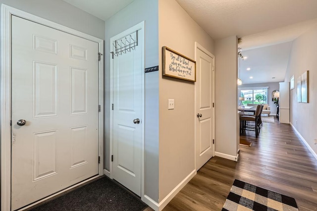 6908 101st St S, Cottage Grove, MN 55016 - hall featuring dark wood-style flooring and baseboards