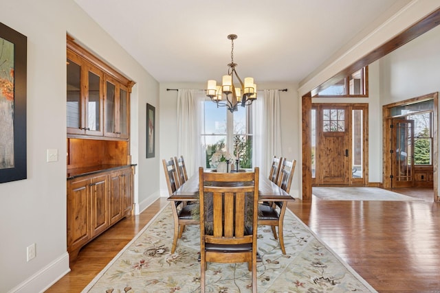 7530 Quail Ridge Trl, Greenfield, MN 55373 - dining room featuring a chandelier and light wood-type flooring