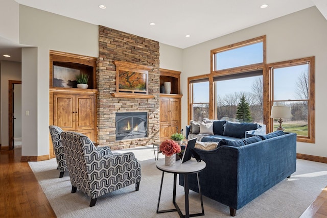 7530 Quail Ridge Trl, Greenfield, MN 55373 - living room with wood finished floors, a stone fireplace, recessed lighting, and a high ceiling