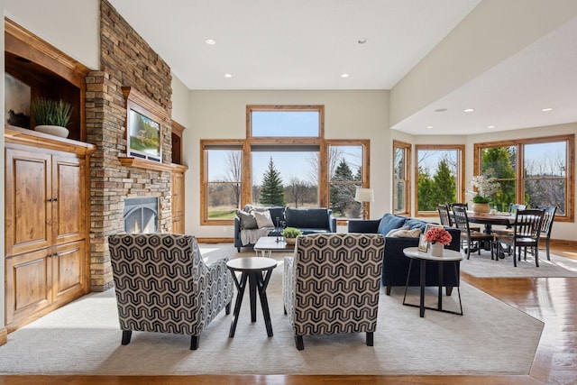 7530 Quail Ridge Trl, Greenfield, MN 55373 - living room featuring a fireplace, recessed lighting, and light wood finished floors