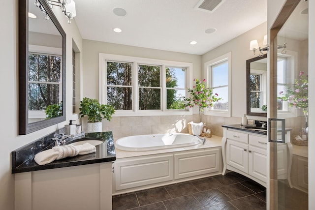 7530 Quail Ridge Trl, Greenfield, MN 55373 - bathroom with vanity, a garden tub, tile patterned floors, recessed lighting, and a shower with shower door