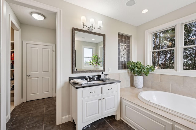 7530 Quail Ridge Trl, Greenfield, MN 55373 - full bathroom with vanity, a garden tub, and tile patterned flooring