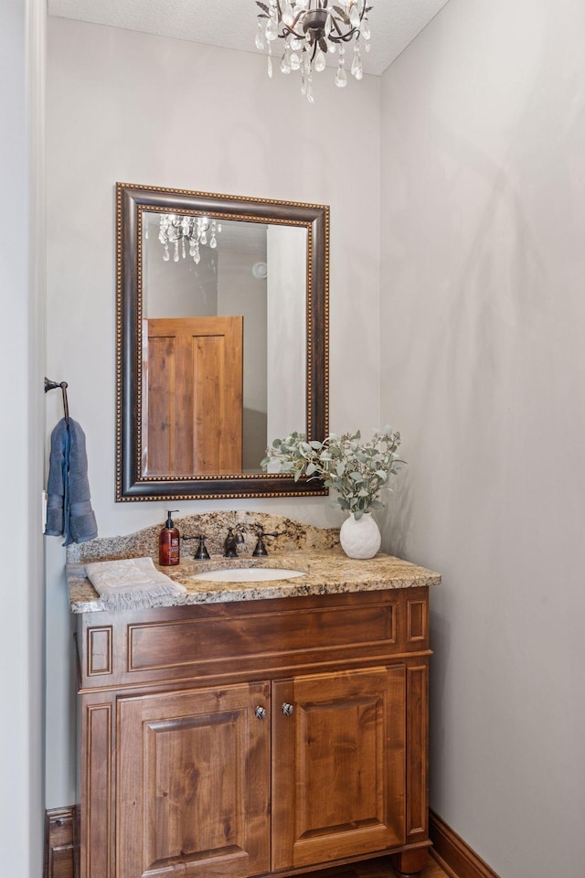 7530 Quail Ridge Trl, Greenfield, MN 55373 - bathroom with a chandelier and vanity