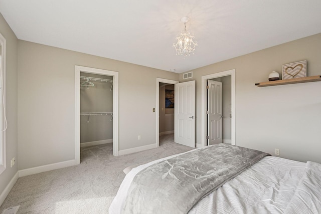 7530 Quail Ridge Trl, Greenfield, MN 55373 - bedroom featuring carpet flooring, a chandelier, a spacious closet, and a closet