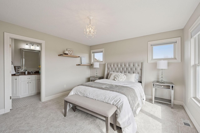 7530 Quail Ridge Trl, Greenfield, MN 55373 - bedroom with light colored carpet, a chandelier, and connected bathroom
