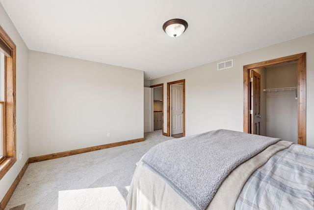 7530 Quail Ridge Trl, Greenfield, MN 55373 - bedroom with light colored carpet and a walk in closet