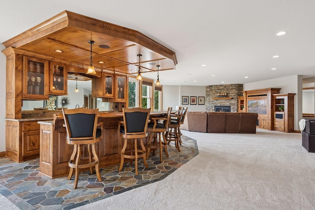 7530 Quail Ridge Trl, Greenfield, MN 55373 - indoor wet bar featuring dark carpet, recessed lighting, a fireplace, and decorative light fixtures