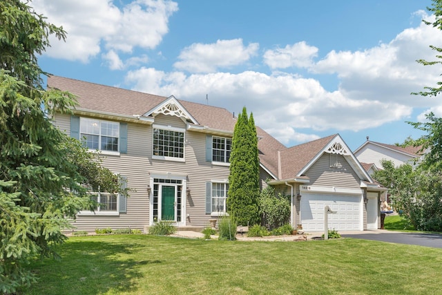 14916 Overlook Dr, Savage, MN 55378 - colonial-style house featuring asphalt driveway, a front yard, and a garage