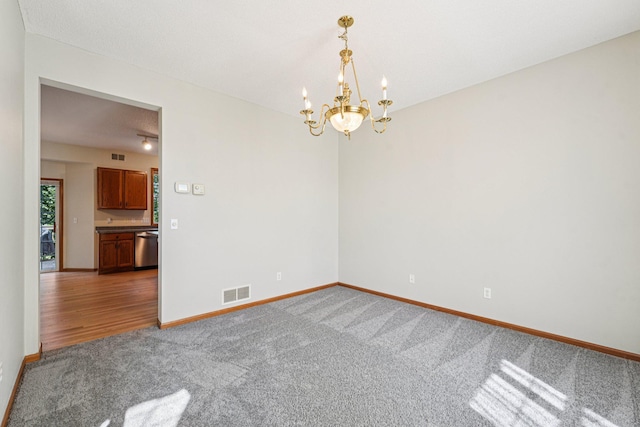 14916 Overlook Dr, Savage, MN 55378 - spare room with carpet flooring and a chandelier