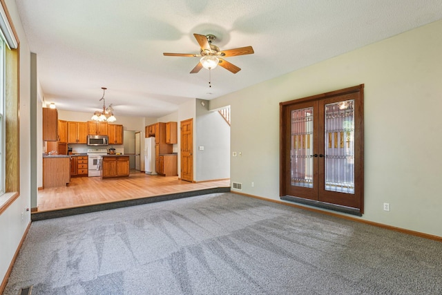 14916 Overlook Dr, Savage, MN 55378 - unfurnished living room with light carpet, a chandelier, and ceiling fan