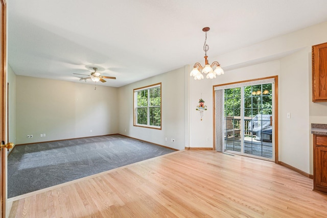 14916 Overlook Dr, Savage, MN 55378 - empty room with light wood-type flooring, ceiling fan, and a chandelier