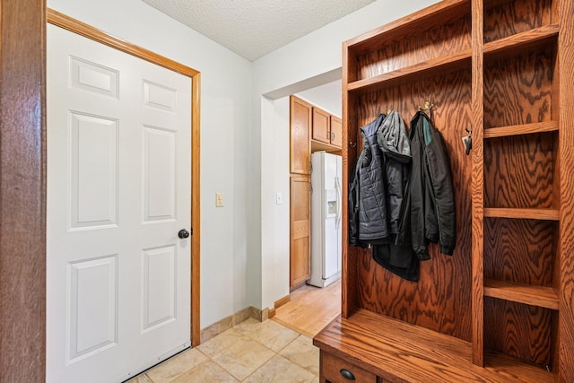 14916 Overlook Dr, Savage, MN 55378 - mudroom featuring baseboards and a textured ceiling