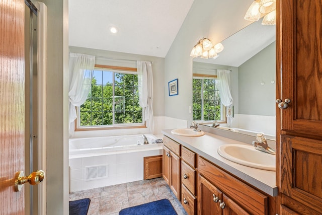 14916 Overlook Dr, Savage, MN 55378 - bathroom with vaulted ceiling, a bath, and double vanity