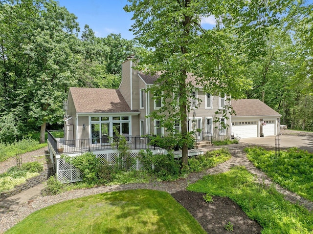 2261 Ash St, Lino Lakes, MN 55110 - view of front facade with concrete driveway, a garage, a shingled roof, a chimney, and a front yard