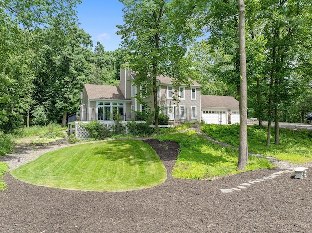 2261 Ash St, Lino Lakes, MN 55110 - view of front of house featuring a front yard, a chimney, and a detached garage