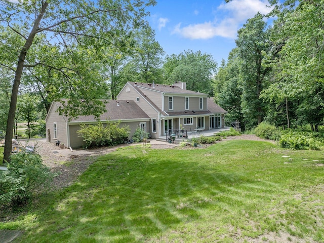 2261 Ash St, Lino Lakes, MN 55110 - rear view of house with a patio, a yard, and a chimney