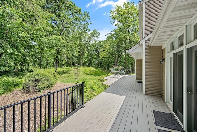 2261 Ash St, Lino Lakes, MN 55110 - wooden deck with outdoor dining space and a lawn