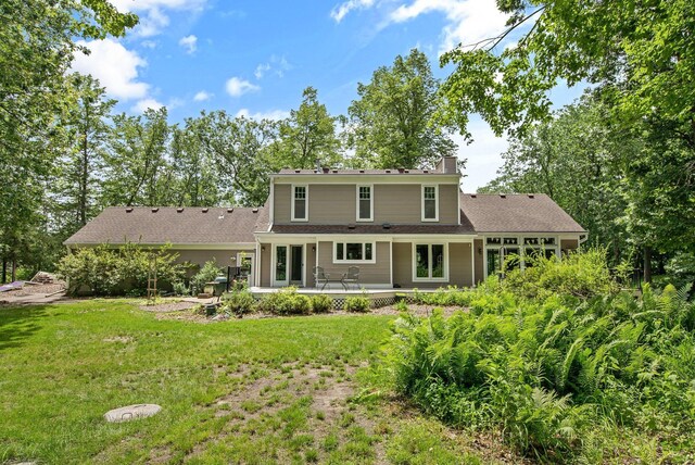 2261 Ash St, Lino Lakes, MN 55110 - rear view of house featuring a lawn, a chimney, and a patio
