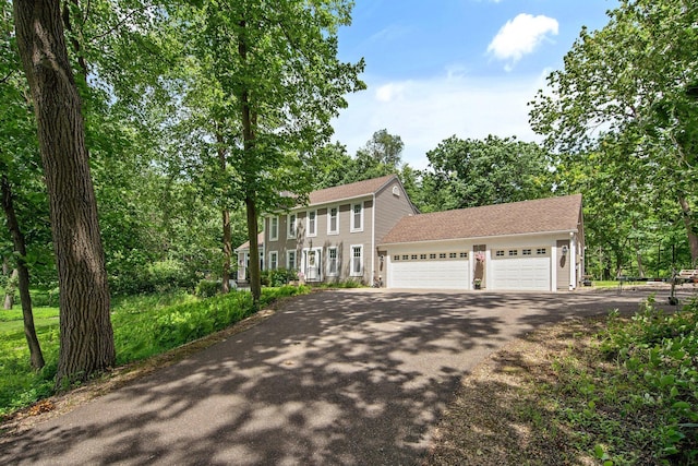 2261 Ash St, Lino Lakes, MN 55110 - colonial house featuring asphalt driveway, an attached garage, and a shingled roof