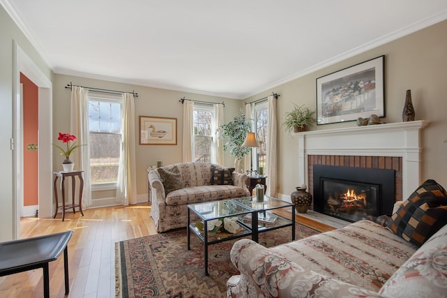 2261 Ash St, Lino Lakes, MN 55110 - living room with a brick fireplace, ornamental molding, and wood finished floors