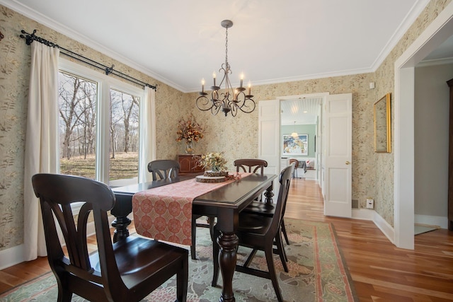 2261 Ash St, Lino Lakes, MN 55110 - dining area with wallpapered walls, wood finished floors, a chandelier, and ornamental molding