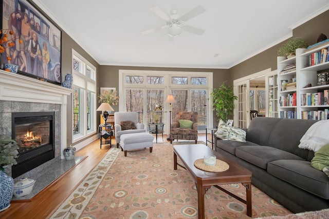 2261 Ash St, Lino Lakes, MN 55110 - living room featuring crown molding, ceiling fan, wood finished floors, and a high end fireplace