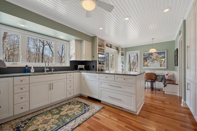 2261 Ash St, Lino Lakes, MN 55110 - kitchen featuring a peninsula, wood ceiling, light wood-style floors, ceiling fan, and decorative light fixtures
