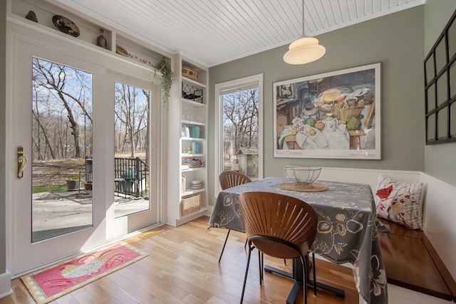 2261 Ash St, Lino Lakes, MN 55110 - dining space featuring hardwood / wood-style floors, built in shelves, and crown molding