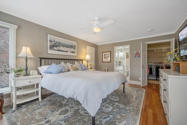2261 Ash St, Lino Lakes, MN 55110 - bedroom featuring light wood-type flooring, crown molding, a closet, ensuite bathroom, and a walk in closet