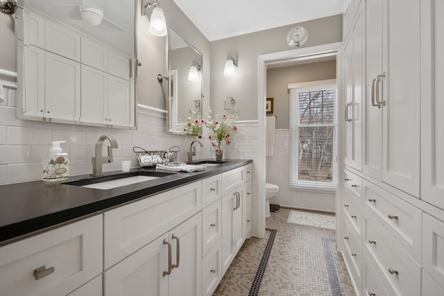 2261 Ash St, Lino Lakes, MN 55110 - full bath with double vanity, tile walls, and wainscoting