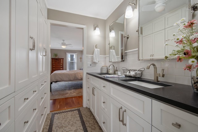 2261 Ash St, Lino Lakes, MN 55110 - ensuite bathroom with a ceiling fan, double vanity, ornamental molding, and backsplash