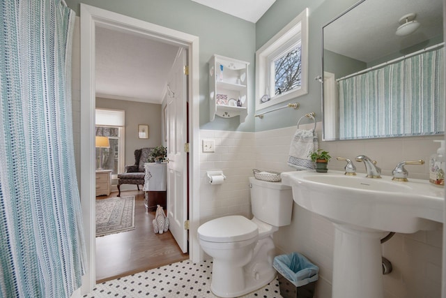 2261 Ash St, Lino Lakes, MN 55110 - bathroom with tile walls, curtained shower, and ornamental molding