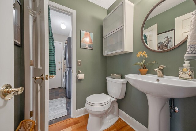2261 Ash St, Lino Lakes, MN 55110 - bathroom featuring stacked washer / dryer and wood finished floors