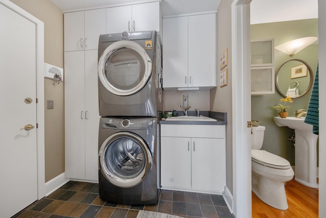 2261 Ash St, Lino Lakes, MN 55110 - laundry area featuring stacked washer and clothes dryer and baseboards