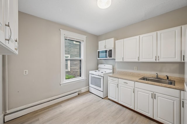 61 Delos St W, Saint Paul, MN 55107 - kitchen with white appliances, a baseboard heating unit, white cabinets, light wood-style floors, and light countertops