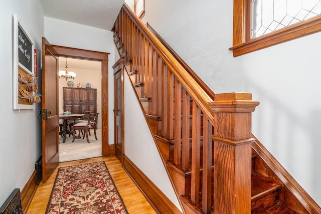 217 6th St, Crookston, MN 56716 - stairs featuring a chandelier and wood finished floors