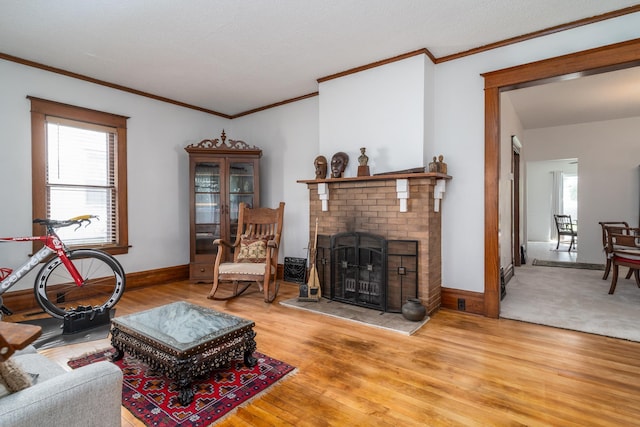 217 6th St, Crookston, MN 56716 - living area featuring light wood-style flooring, healthy amount of natural light, a brick fireplace, and crown molding