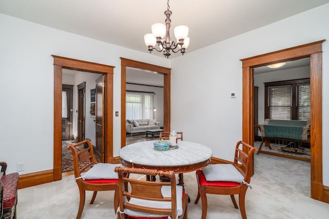 217 6th St, Crookston, MN 56716 - dining space featuring a chandelier and light colored carpet