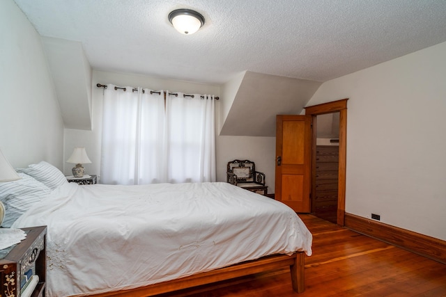 217 6th St, Crookston, MN 56716 - bedroom with hardwood / wood-style flooring and a textured ceiling