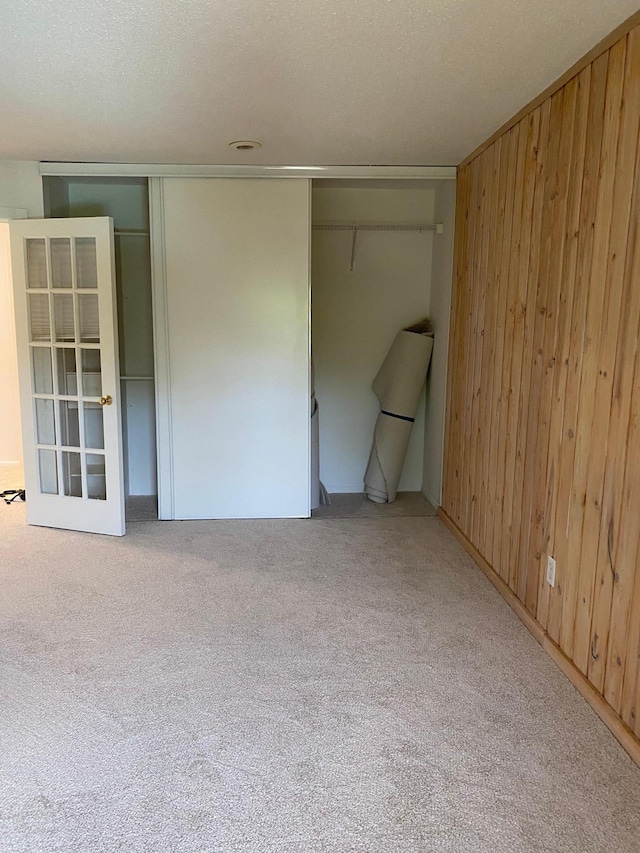 10113 34th St Unit 335, Minnetonka, MN 55305 - unfurnished bedroom featuring carpet floors, wooden walls, and a closet