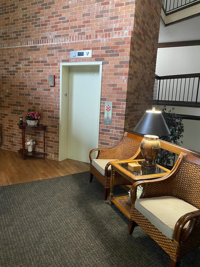 10113 34th St Unit 335, Minnetonka, MN 55305 - sitting room with wood finished floors, elevator, and brick wall