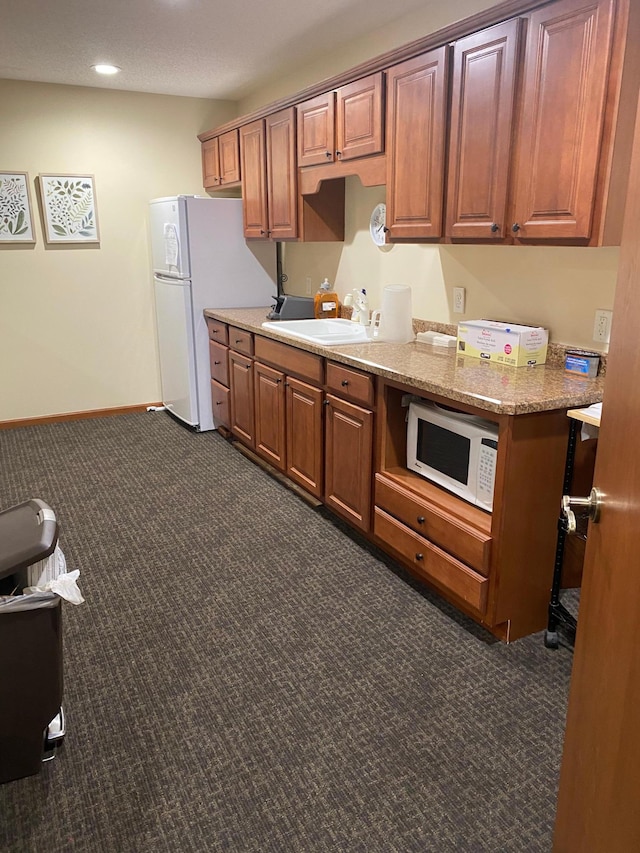 10113 34th St Unit 335, Minnetonka, MN 55305 - kitchen with white microwave, dark colored carpet, brown cabinets, and recessed lighting