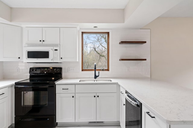 434 11th St Unit D, New Richmond, WI 54017 - kitchen with black range with electric stovetop, white microwave, dishwashing machine, open shelves, and decorative backsplash