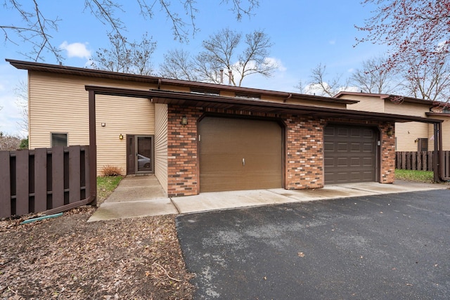 434 11th St Unit D, New Richmond, WI 54017 - view of front of home featuring brick siding, an attached garage, and driveway