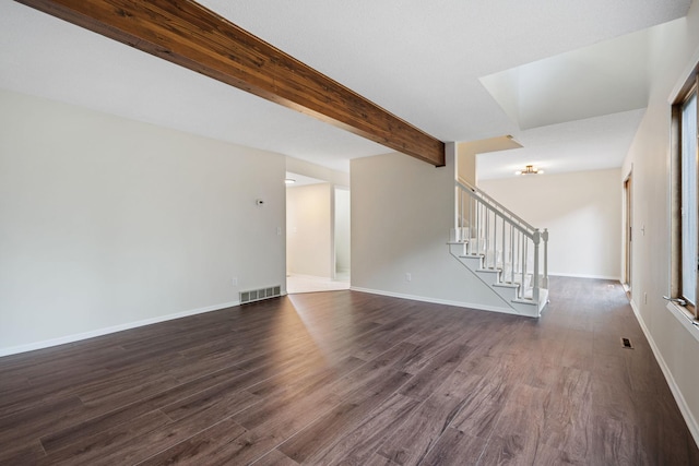 434 11th St Unit D, New Richmond, WI 54017 - unfurnished living room with dark wood-type flooring, stairway, and beam ceiling