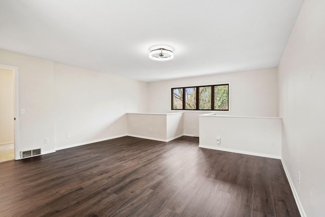 434 11th St Unit D, New Richmond, WI 54017 - empty room with dark wood finished floors and baseboards