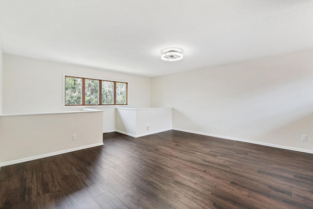 434 11th St Unit D, New Richmond, WI 54017 - spare room featuring dark wood-type flooring and baseboards